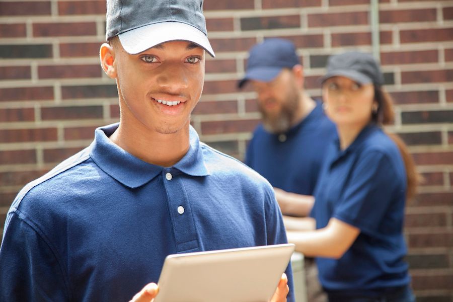 A technician holds a clipboard. Zone Your Way to Comfort.