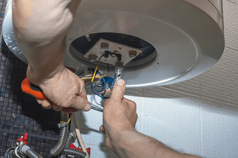 Image of someone working on a furnace. What Are Signs I Need a New Furnace?