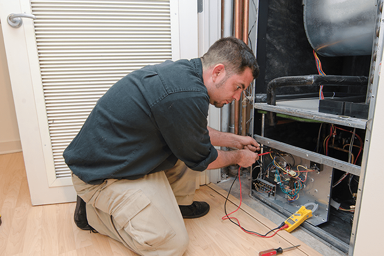 A man works on a ductless system. Planning to Remodel? Go Ductless!