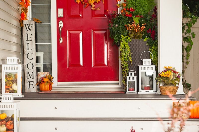 A red door with fall decor. Preparing Your HVAC System for the Fall.