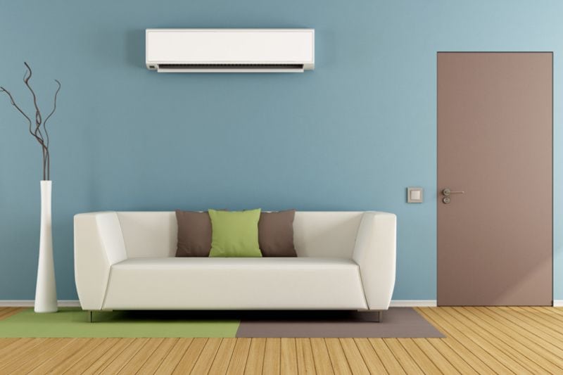 Image of ductless system above a couch. Why Ductless Is the Way to Go.